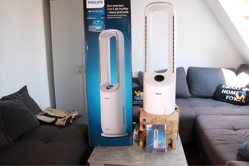 Der Philips Air Performer Series 7000 (AMF765/10) steht auf einem Couchtisch neben dem Karton.